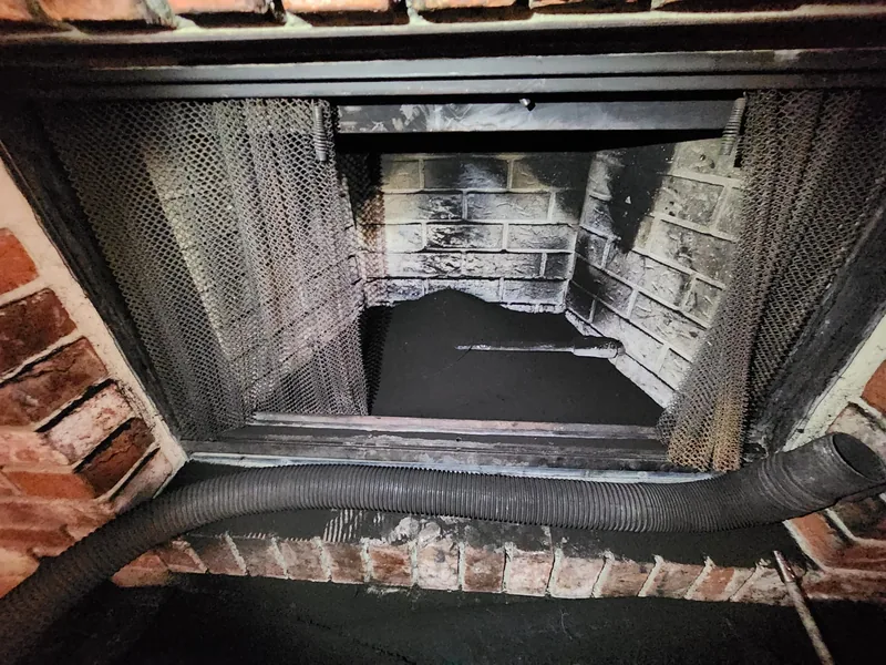 Thick third-degree creosote coating the smoke chamber walls of a Sacramento area masonry chimney