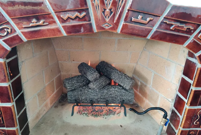 Gas log fireplace burning with a clean steady flame after burner and pilot assembly servicing